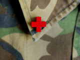Red Cross on the Collar of a Camouflage Jacket Photographic Print by Images Monsoon