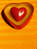 A Love Stone Heart with Yellow Background Photographic Print by Images Monsoon