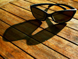 Sunglasses and their Shadow on a Wooden Table Photographic Print by Images Monsoon