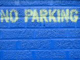 Painted Blue Brick Wall with No Parking Sign Fotografie-Druck von John Nordell