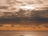 Cloudy, Orange Skies over Body of Water Photographic Print by Images Monsoon