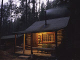 Wood Smoke Rises from the Chimney of a Log Cabin Photographie par Joel Sartore