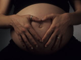 Nine Month Pregnant Woman Holds Her Large Belly Photographie par Paul Damien