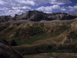 Colorful Hills under a Cloudy Sky in the Western Badlands Photographie par Paul Damien