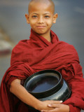 Young Myanmar Buddhist Monk Smiles Broadly as He Waits for Donations Early on a Yangon Street Photographic Print