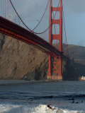 Surfer Rides a Wave Near the Golden Gate Bridge in San Francisco Photographic Print