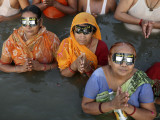 Hindu Devotees Observe a Solar Eclipse as They Take Holy Dips in the Sangam in Allahabad, India Photographic Print