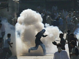 Protesters Run as a Tear Gas Shell Explodes During a Demonstration in Srinagar India Photographic Print