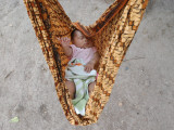 Four-Month-Old Rianto Sleeps in a Batik Cloth Swing, at a Refugee Camp in Lamreh, Indonesia Photographic Print