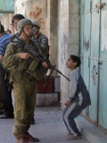 Israeli Soldier Tells a Palestinian Boy to Leave the Scene Following a Knife Attack Photographic Print