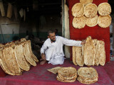 Baker Arranges Breads at His Shop in Kandahar Province, South of Kabul, Afghanistan Photographie