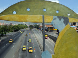 Main Avenue is Empty of Private Cars, Seen from a Bridge Decorated with a Statue of a Pedestrian Photographic Print