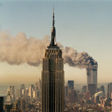 Twin Towers of the World Trade Center Burn Behind the Empire State Buildiing, September 11, 2001 Reprodukcja zdjęcia