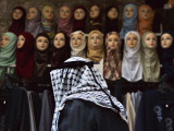 Palestinian Man Passes in Front of a Shop Offering Veils for Sale in Jerusalem's Old City Photographic Print