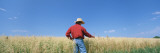 Farmer Standing in an Oat Field, Saunders County, Nebraska, USA Photographic Print by Panoramic Images 