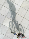 Sun Casts the Shadow of a Cyclist in Berlin, Germany Photographic Print