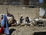 Afghan Street Vendor Speaks with Friend as He Sells Mulberry Pea Nuts and Sun Flower Seeds in Kabul Photographic Print