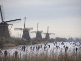 People Skate on Frozen Canals in Kinderdijk's Mill Area, a UNESCO World Heritage Site, Netherlands Photographic Print