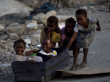 Children Play with a Suitcase Near a Camp for People Displaced by the Earthquake in Port-Au-Prince Photographic Print