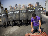 Palestinian Worshipper Prays Outside Jerusalem's Old City While Israeli Forces Stand Guard Photographic Print