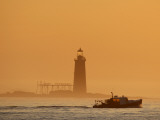 Lobster Boat Passes Ram Island Ledge Light at Dawn Off Cape Elizabeth, Maine Photographic Print