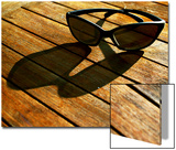 Sunglasses and their Shadow on a Wooden Table Print by Claire Morgan