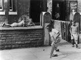 Young Black Boys Play Cricket on the Pavement in Manchester. Photograph by Shirley Baker Photographic Print by Shirley Baker