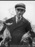 A Cotswolds Farmer Holds Two New-Born Lambs Photographic Print by Henry Grant
