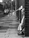 Old Lady Sitting in a Doorway - Manchester 1968 Photographic Print by Shirley Baker