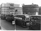 Buses at Trafalgar Squ Photographic Print