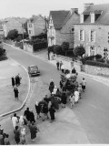 A Funeral Procession in Ireland. Mourners Walk Through the Streets Behind the Coffin Photographic Print