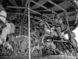 Riding on the Merry-Go-Round Carousel at a Surrey Funfair Photographie par Vanessa Wagstaff