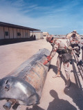 US Soldiers Examining Metal Cyclinder at Operation Desert Storm Premium fotografisk trykk av Dennis Brack