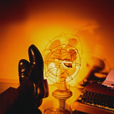 Feet Resting on Desk with Vintage Fan and Typewriter Photographie par Wendy Idele