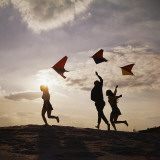 Three Friends Running Flying Kites Photographic Print by Dennis Hallinan
