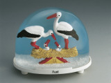 Close-Up of Figurines of Storks in a Snow Globe Photographic Print
