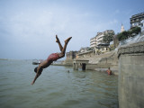 Man Jumping into Ganges River , Varanasi, India Photographic Print by Ami Vitale