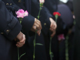 Mourners Hold Flowers Outside Photographic Print by Bulent Kilic