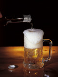 Close-Up of Beer Pouring from a Bottle into a Glass Photographic Print by G. Majno