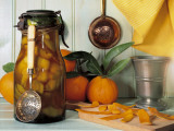 Close-Up of Orange Rinds for Punch Preparation with a Bottle of Pickle Photographic Print by N. Chasseriau