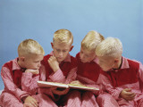 Boys Wearing Pajamas Reading a Book Photographic Print by Dennis Hallinan