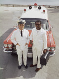 Two Paramedics Stand in Front of Ambulance Photographic Print by Dennis Hallinan