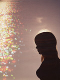 Silhouette of Woman by Water at Dusk Photographic Print by Dennis Hallinan