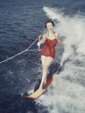 Happy Retro Woman Water Skiing Photographic Print by Dennis Hallinan