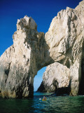 Sea kayaker paddles toward arch of rock, Cabo San Lucas, Baja Photographic Print by Jeff Foott Sea kayaker paddles toward arch of rock, Cabo San Lucas, Baja Photographic Print by Jeff Foott