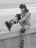 Woman Putting on Rollerblades Wearing Skating Gear Photographic Print