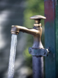 A Faucet and Running Water Photographic Print