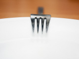 A Fork Resting on the Edge of a Plate Photographic Print