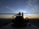 A UH-60 Black Hawk Helicopter on the Flight Line at Sunset Photographic Print