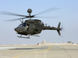 An Oh-58D Kiowa Warrior Hovers over the Flight Line at Camp Speicher, Iraq Photographic Print